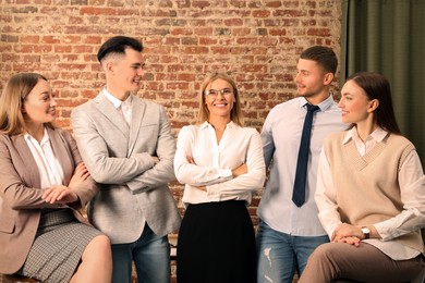 Photo of Businesswoman and her employees in office. Lady boss