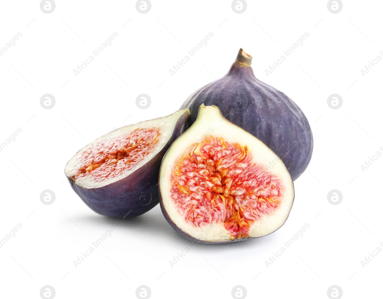 Photo of Whole and cut purple figs on white background