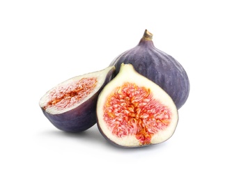 Whole and cut purple figs on white background