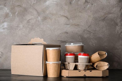 Various takeout containers on table, space for text. Food delivery service