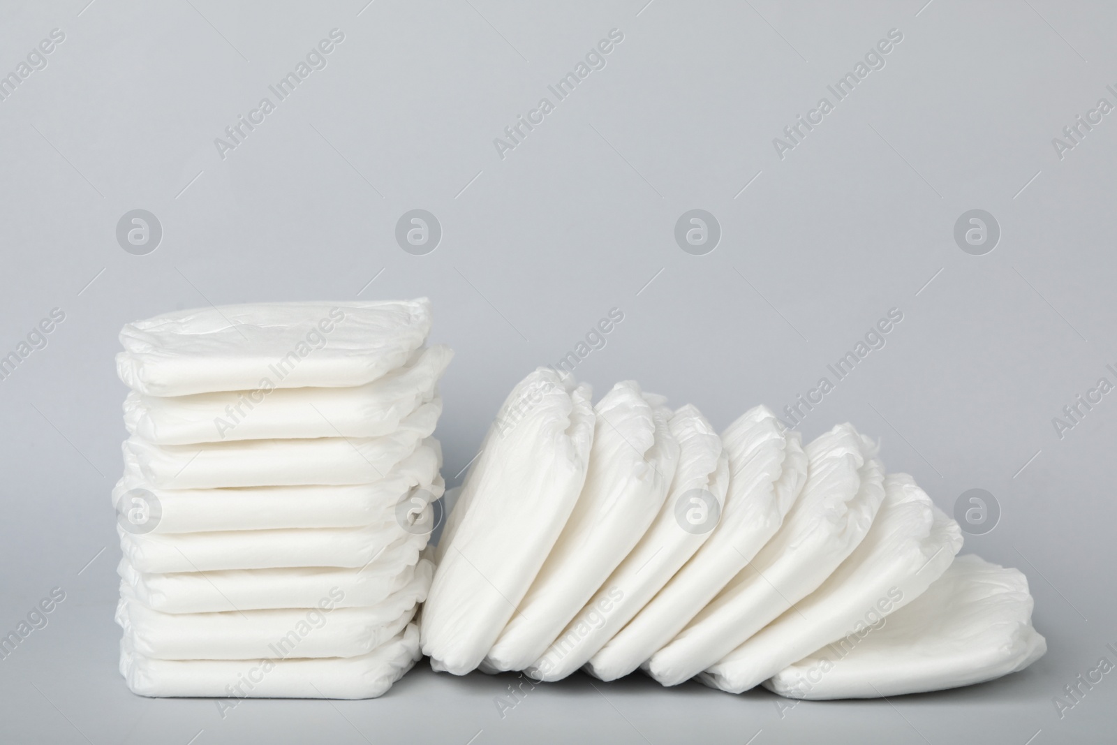 Photo of Pile of baby diapers on light grey background