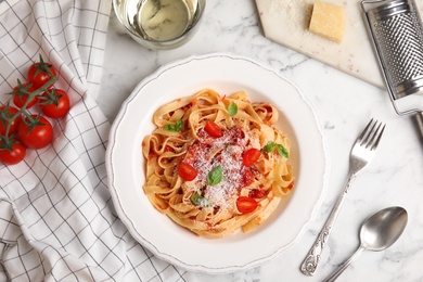 Photo of Flat lay composition with tasty pasta on white marble table