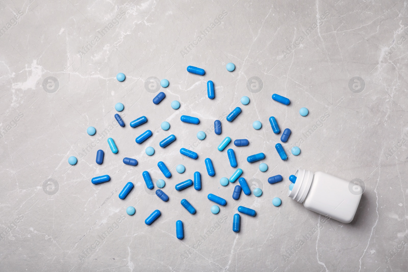 Photo of Bottle with pills on table