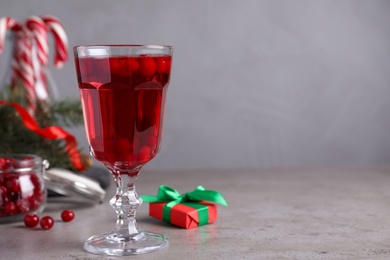 Delicious Christmas liqueur on grey table, closeup. Space for text