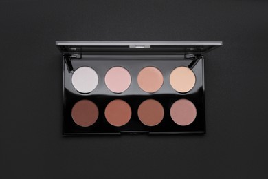 Photo of Contouring palette on black background, top view. Professional cosmetic product