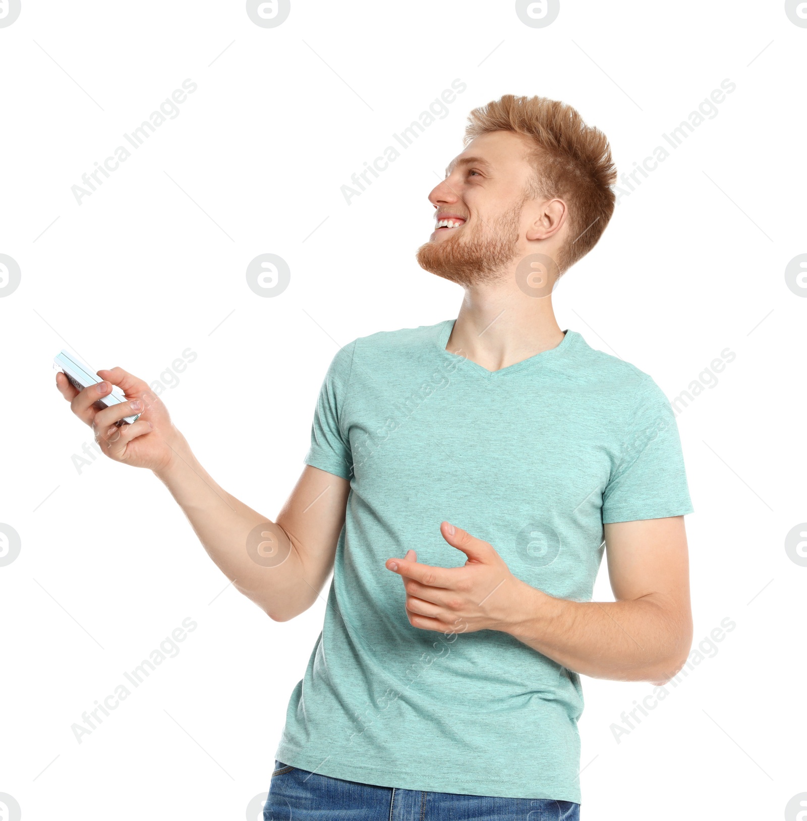 Photo of Young man with air conditioner remote on white background