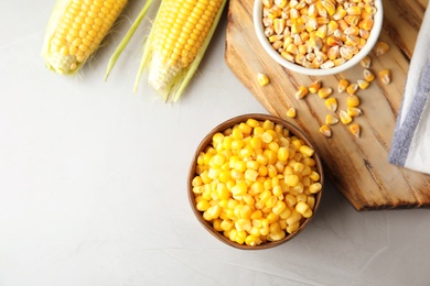 Flat lay composition with corn kernels on grey background. Space for text