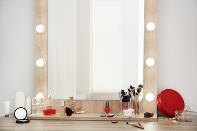 Makeup cosmetic products and tools on dressing table