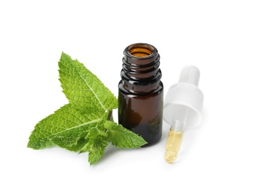 Bottle of essential oil and mint on white background