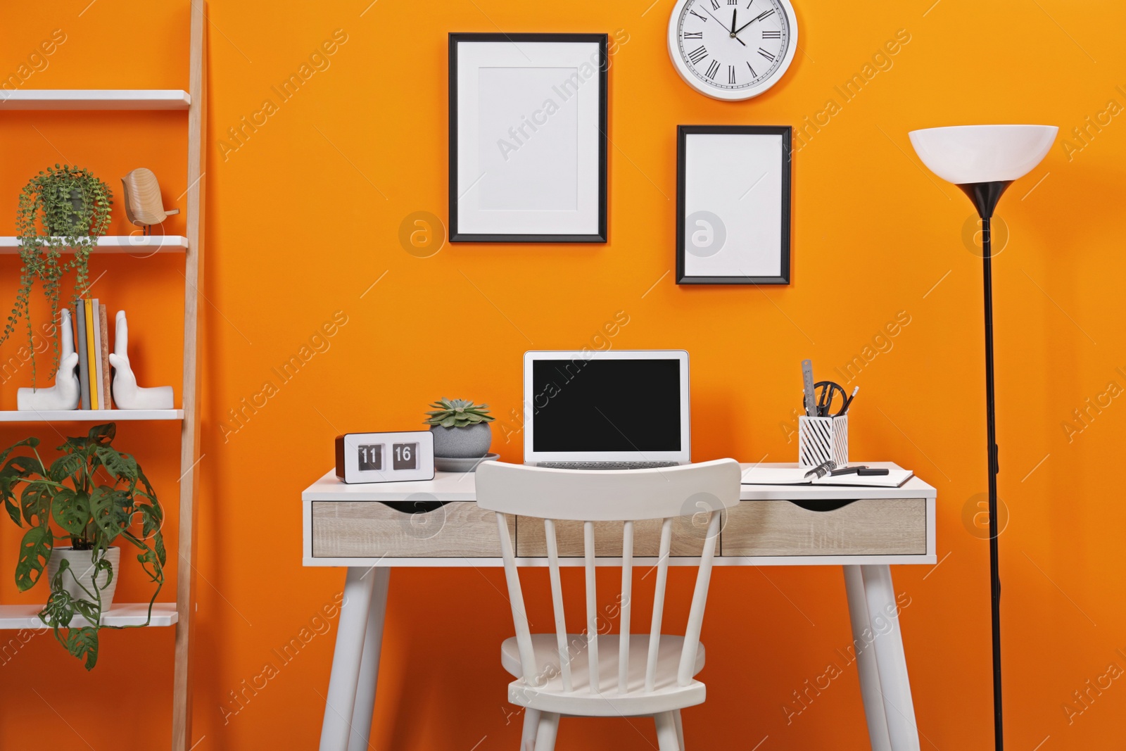 Photo of Workplace with laptop, stationery on desk and chair in home office