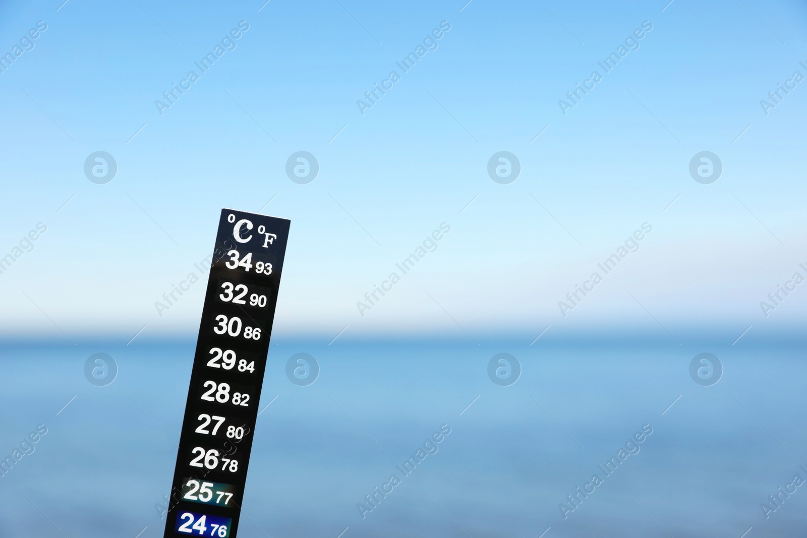 Photo of Weather thermometer at seaside, space for text