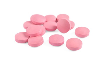Photo of Pile of pink pills on white background