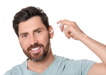 Man using ear spray on white background