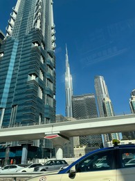 Dubai, United Arab Emirates - May 2, 2023: Beautiful view of Burj Khalifa and buildings in city under blue sky