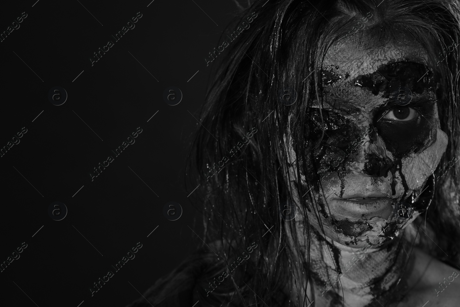 Photo of Scary zombie on dark background, black and white effect with space for text. Halloween monster