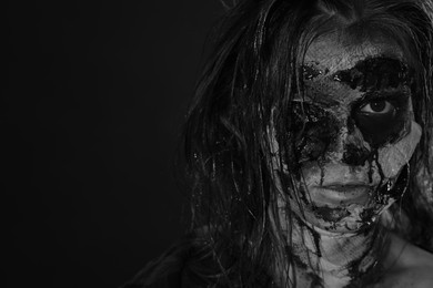 Photo of Scary zombie on dark background, black and white effect with space for text. Halloween monster