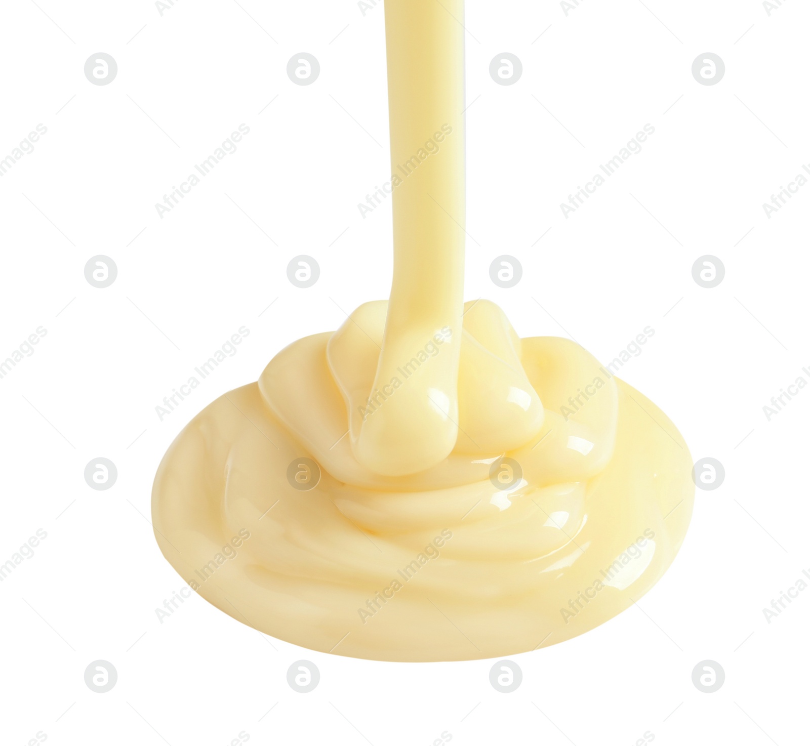 Photo of Tasty pouring condensed milk on white background. Dairy product