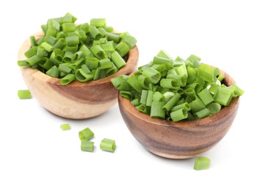Photo of Chopped fresh green onion in bowls isolated on white