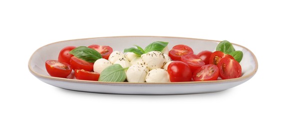 Photo of Plate of delicious Caprese salad with tomatoes, mozzarella, basil and spices isolated on white