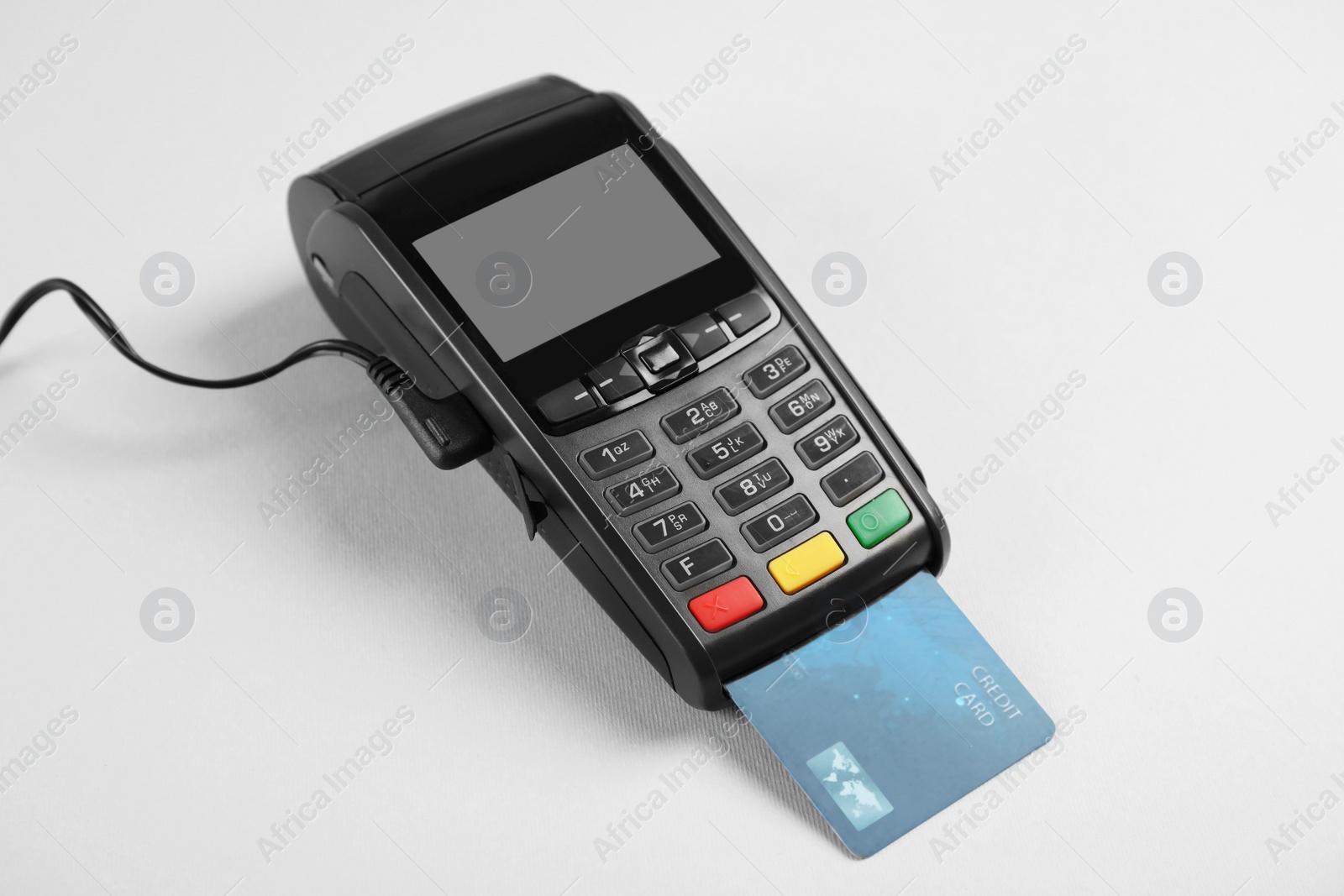 Photo of Modern payment terminal with credit card on grey background