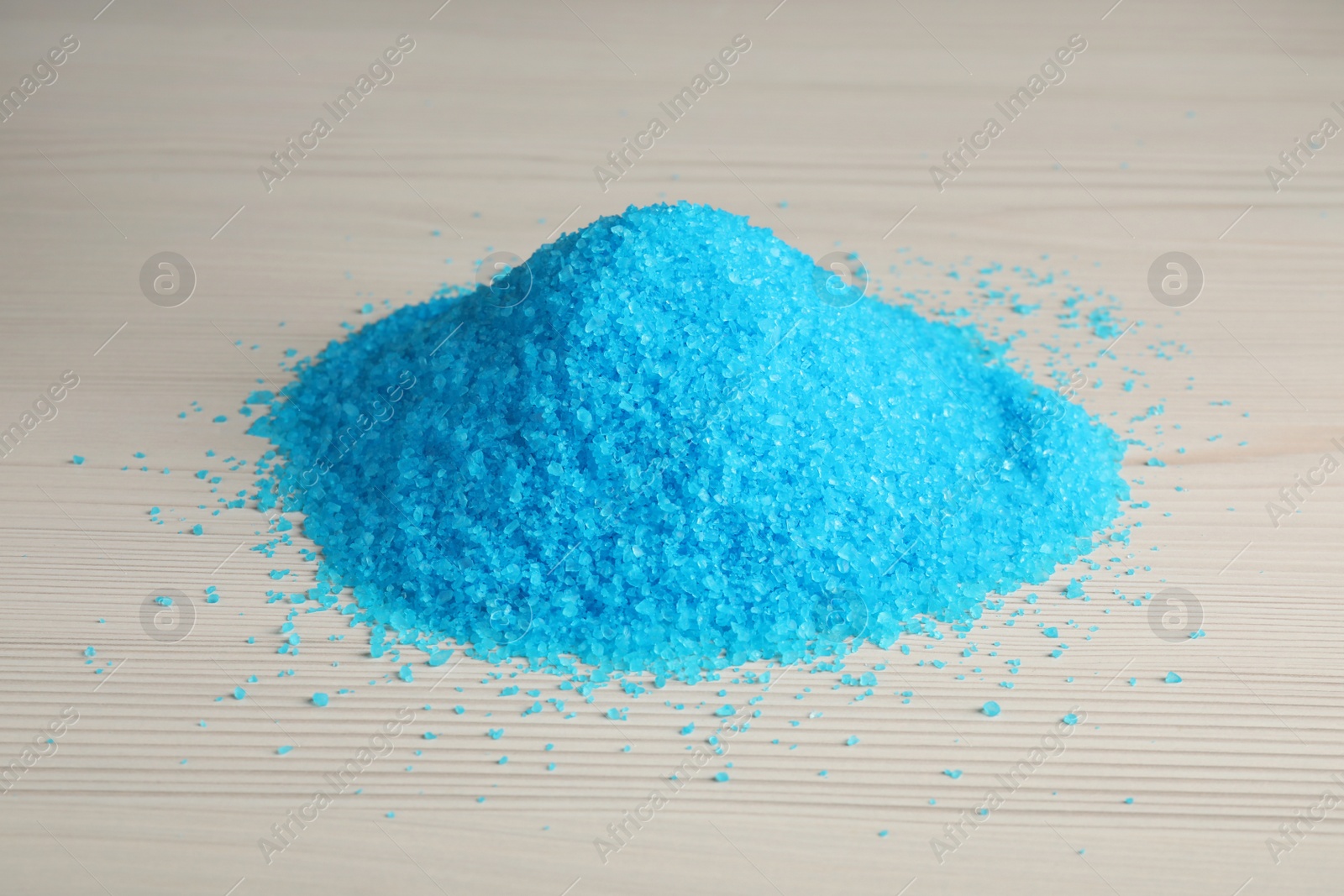 Photo of Pile of aromatic sea salt on white wooden table, closeup