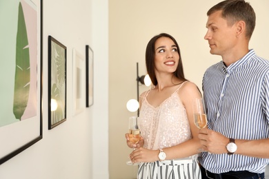 Young couple at exhibition in art gallery