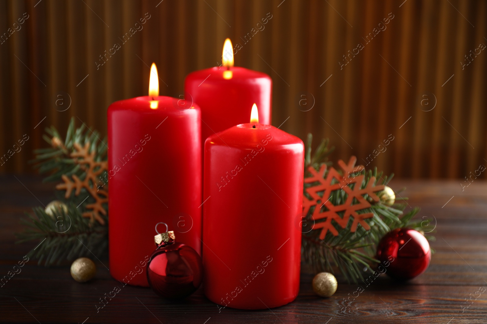 Photo of Beautiful composition with candles and Christmas decor on wooden table