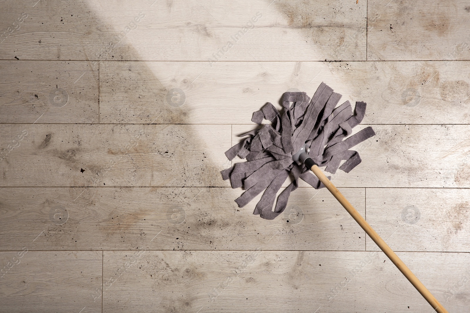 Photo of Washing of dirty floor with mop, top view. Space for text