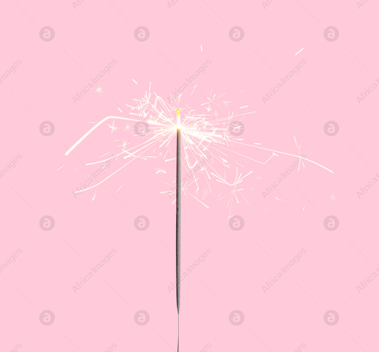 Image of Beautiful sparkler burning on pink background. Party decor