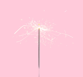 Image of Beautiful sparkler burning on pink background. Party decor