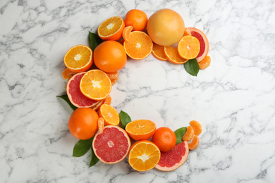 Photo of Letter C made with citrus fruits on marble table as vitamin representation, flat lay
