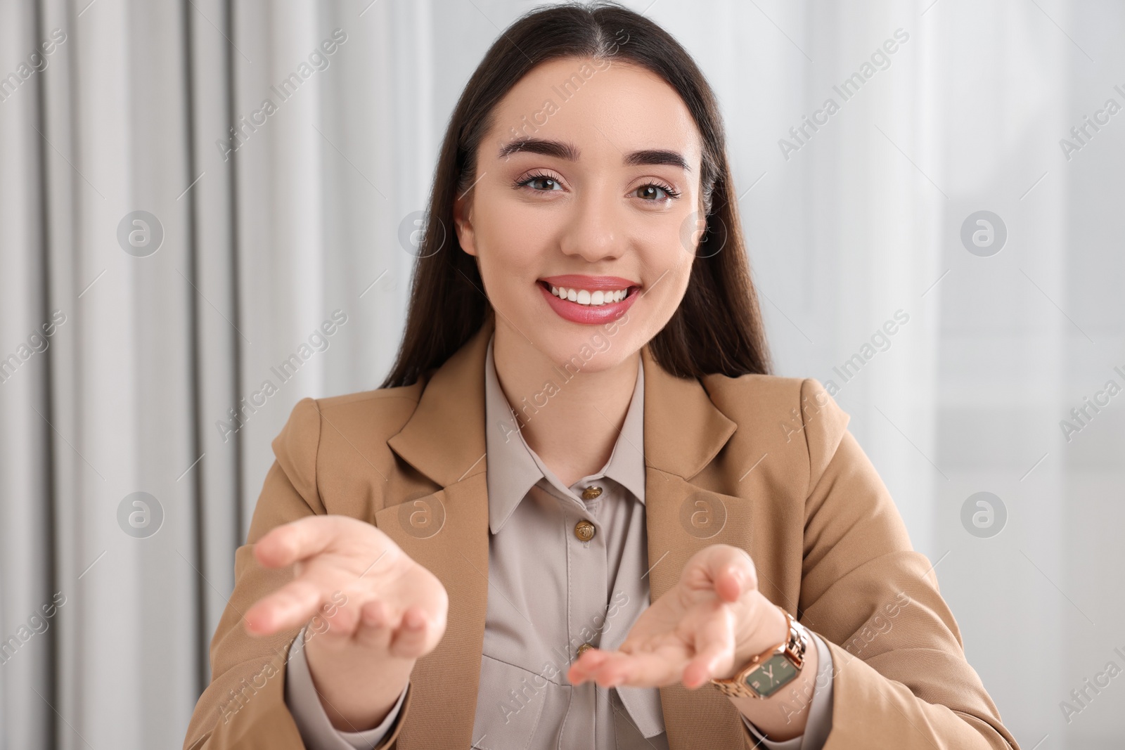 Photo of Beautiful young woman having online video call at home, view from camera