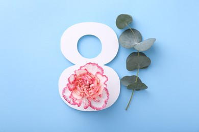 Photo of Paper number 8, beautiful flower and eucalyptus branch on light blue background, top view