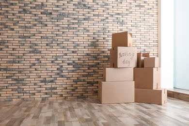 Photo of Pile of moving boxes in empty room