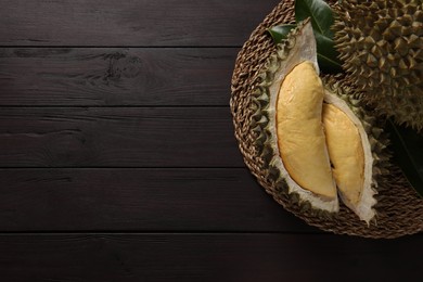 Photo of Fresh ripe durians on wooden table, top view. Space for text