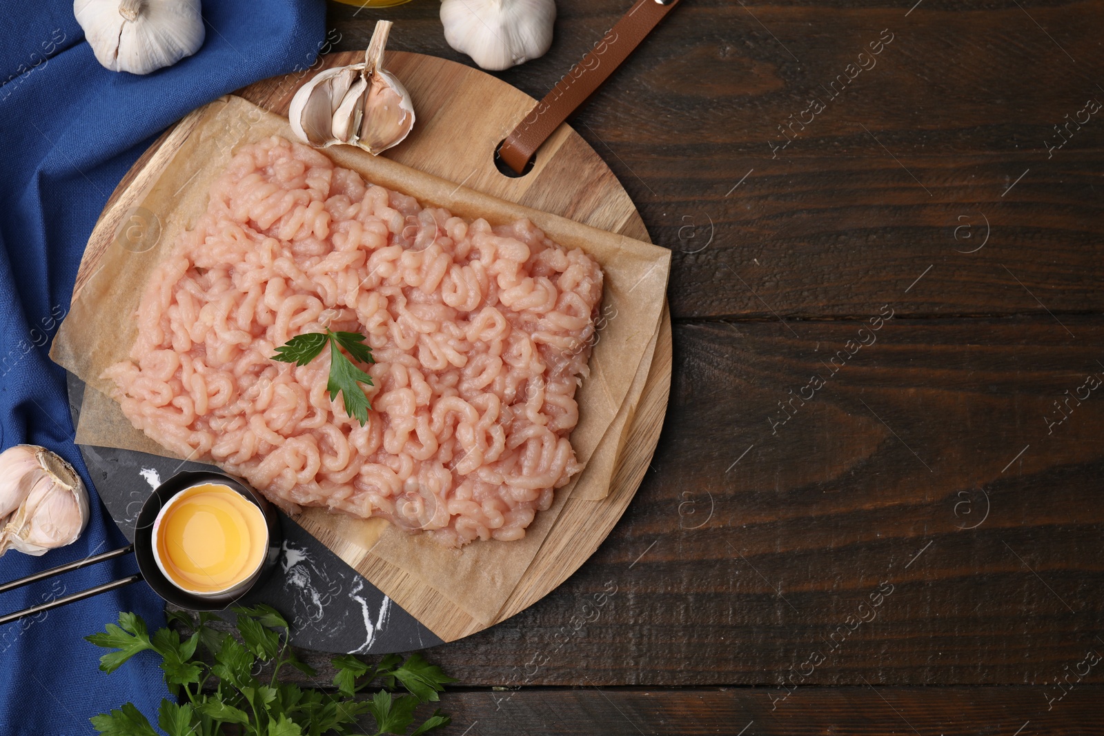 Photo of Flat lay composition with fresh raw minced meat and products on wooden table. Space for text