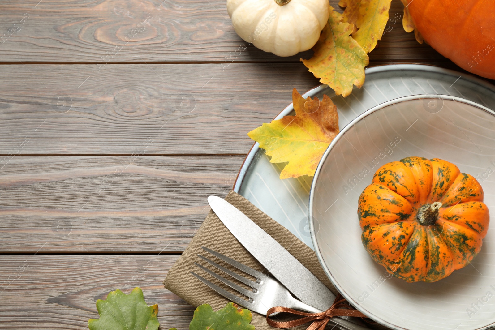 Photo of Festive table setting on wooden background, flat lay with space for text. Thanksgiving Day celebration