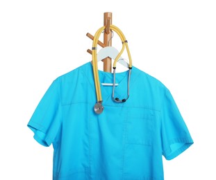 Turquoise medical uniform and stethoscope on rack against white background