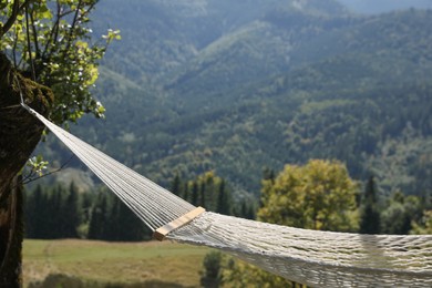 Empty comfortable net hammock in mountains on sunny day