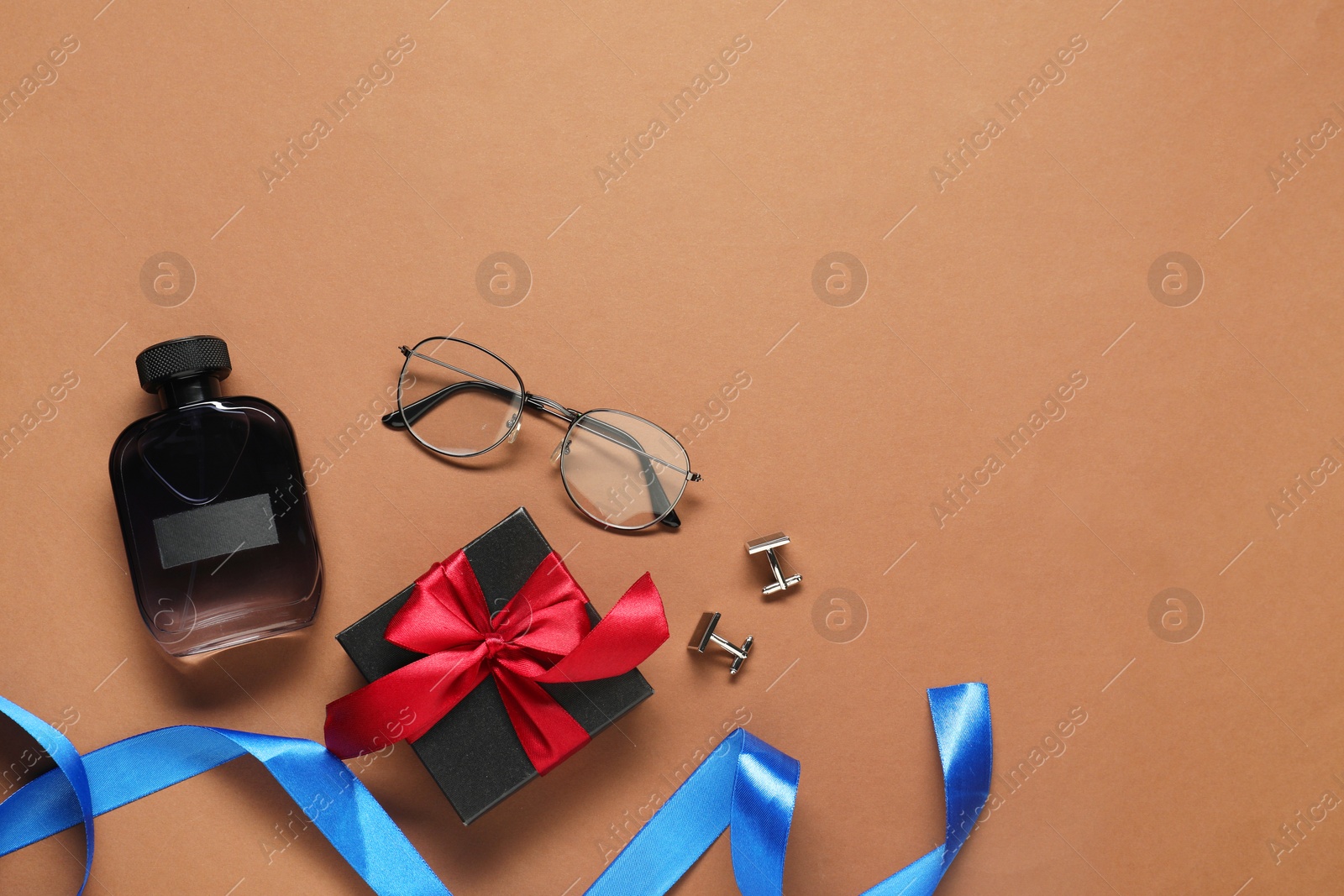 Photo of Luxury perfume, gift box and men accessories on brown background, flat lay with space for text. Father's day celebration