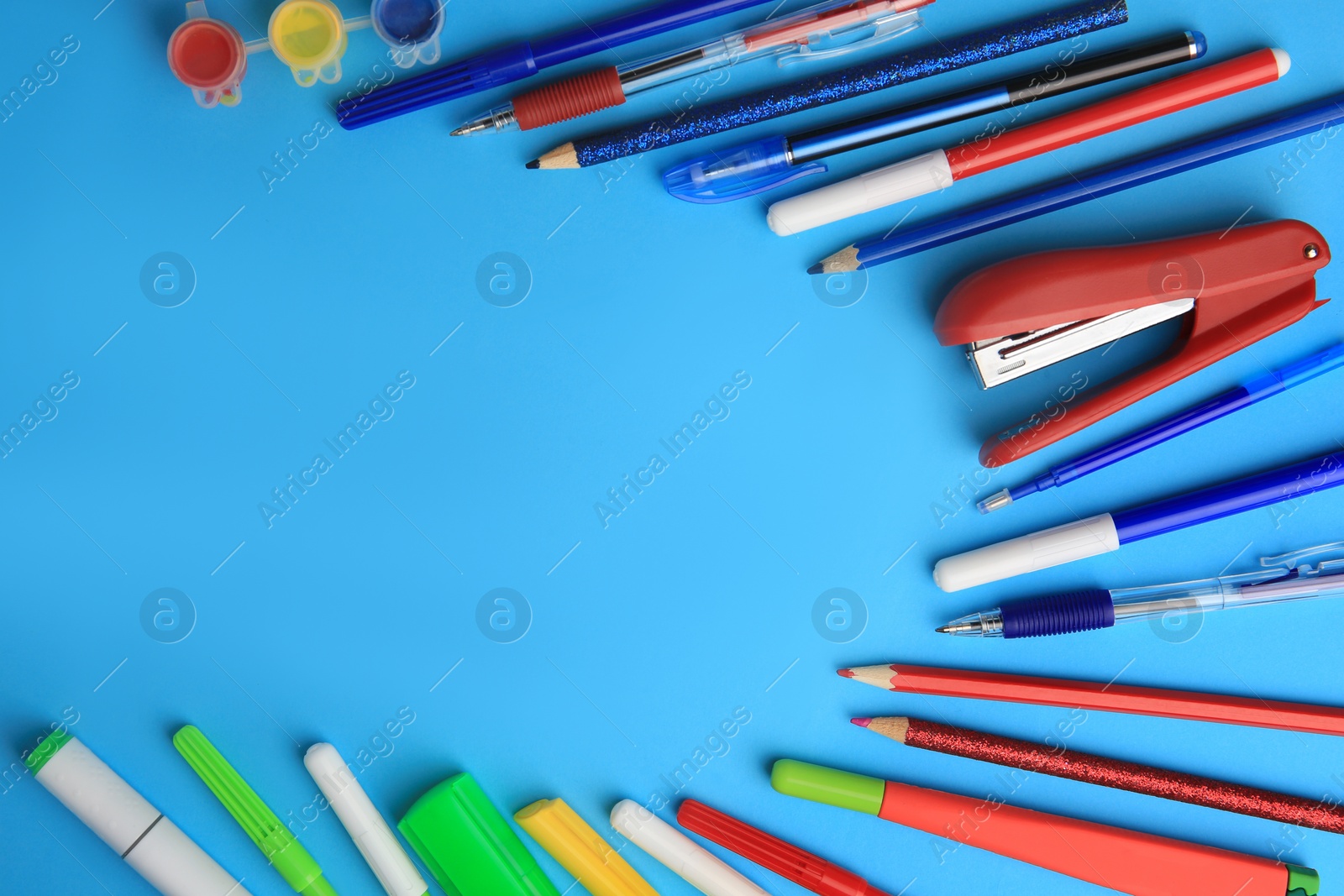 Photo of Flat lay composition with different school stationery on light blue background, space for text. Back to school