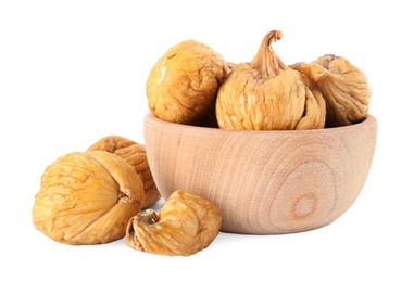 Wooden bowl and dried figs on white background