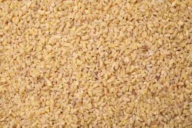 Uncooked organic bulgur as background, top view