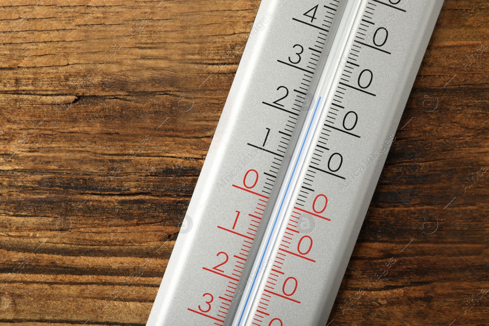 Photo of Modern weather thermometer on wooden background, closeup