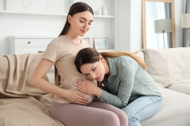 Doula taking care of pregnant woman at home. Preparation for child birth