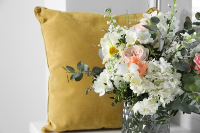 Photo of Bouquet of beautiful fresh flowers near pillow