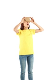 Young woman using cardboard virtual reality headset, isolated on white