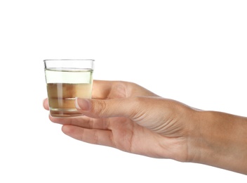 Photo of Woman holding glass with mouthwash for teeth care on white background