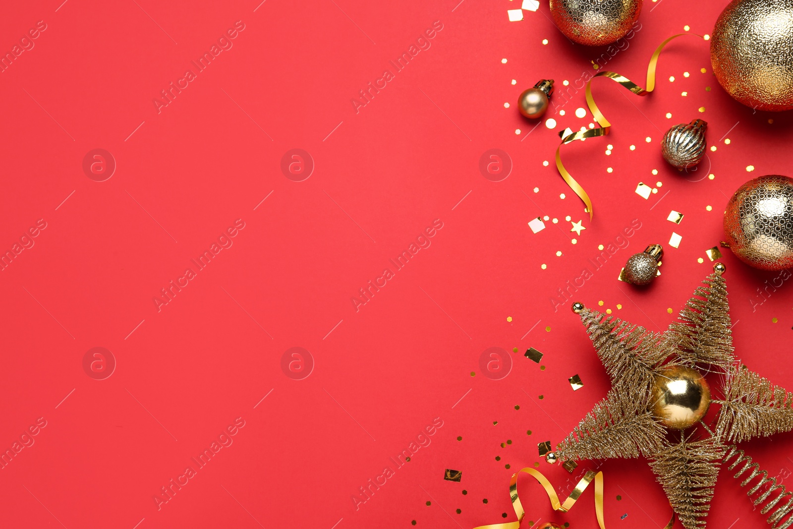 Photo of Flat lay composition with Christmas balls and star on red background, space for text