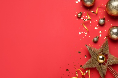 Flat lay composition with Christmas balls and star on red background, space for text